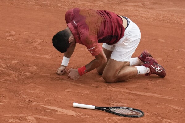 Serbia's Novak Djokovic slipped and fell during the fourth round match of the French Open tennis tournament against Argentina's Francisco Cerundolo at the Roland Garros stadium in Paris, Monday, June 3, 2024. (AP Photo/Christophe Ena)