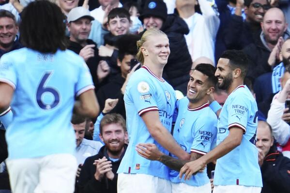 Manchester City's Erling Haaland, centre, celebrates with teammates after scoring their side's fourth goal during the English Premier League soccer match between Manchester City and Southampton at Etihad stadium in Manchester, England, Saturday, Oct. 8, 2022. (AP Photo/Jon Super)