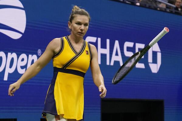 Simona Halep, of Romania, tosses her racket as she plays Elina Svitolina, of Ukraine, during the fourth round of the US Open tennis championships, Sunday, Sept. 5, 2021, in New York. (AP Photo/Seth Wenig)