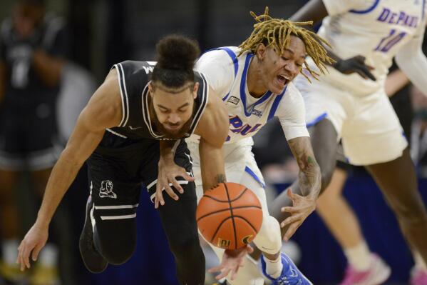 Providence's Jared Bynum (4) battles DePaul's Jalen Terry (3) for a loose ball during the first half of an NCAA college basketball game Saturday, Jan.1, 2022, in Chicago. (AP Photo/Paul Beaty)
