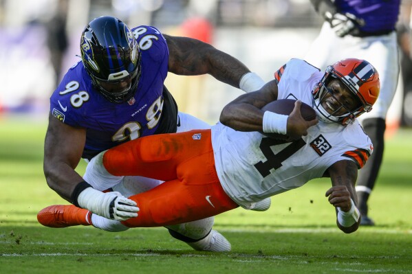 Cleveland Browns quarterback Deshaun Watson is tackled by Baltimore Ravens defensive tackle Travis Jones during the first half on an NFL football game Sunday, Nov. 12, 2023, in Baltimore. (AP Photo/Nick Wass)