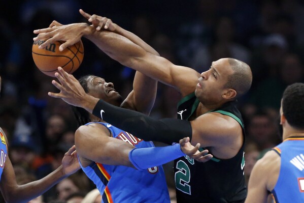 Boston Celtics center Al Horford, right, and Oklahoma City Thunder forward Jalen Williams, left, try to rebound the ball during the first half of an NBA basketball game, Tuesday, Jan. 2, 2024, in Oklahoma City. (AP Photo/Nate Billings)
