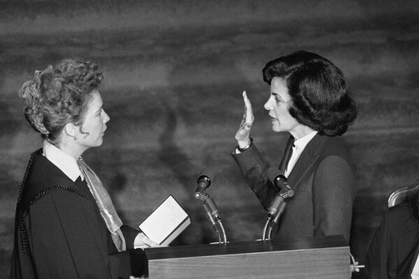 FILE - Chief Justice Rose Bird, left, administers the oath of office as Dianne Feinstein is sworn in as mayor of San Francisco during ceremonies in the City Hall, San Francisco, Jan. 8, 1980. Democratic Sen. Dianne Feinstein of California has died. She was 90. (AP Photo/Sal Veder, File)