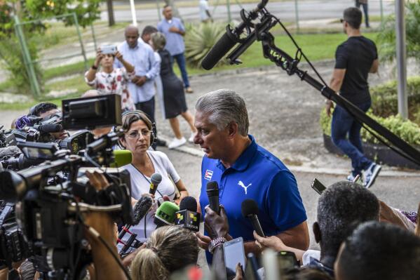 Cuba's President Miguel Diaz Canel speaks to the press after casting his vote at a polling station during the new Family Code referendum in Havana, Cuba, Sunday, Sept. 25, 2022. The draft of the new Family Code, which has more than 480 articles, was drawn up by a team of 30 experts, and it is expected to replace the current one that dates from 1975 and has been overtaken by new family structures and social changes. (AP Photo/Ramon Espinosa)