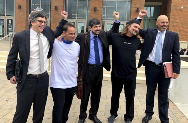 FILE - Ricky Birch, second from left, and Shawn Henning, second from right, celebrate with their attorneys after the state permanently dismissed their murder charges, Friday, July 10, 2020, at Torrington Superior Court in Torrington, Conn. A federal judge on Friday, July 21, 2024, has found famed forensic scientist Henry Lee liable for fabricating evidence in a murder case that sent the two men to prison, one for more than three decades, for a crime they did not commit. Birch and Henning were convicted of felony murder in the Dec. 1, 1985, slaying of 65-year-old Everett Carr, of New Milford, based in part on false testimony about blood stains on a towel. (Brigitte Ruthman/Republican-American via AP, File)
