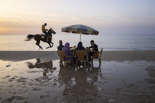 Palestinians enjoy the day on the beach in Gaza City, Thursday, March 2, 2023. (AP Photo/Fatima Shbair)