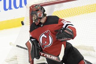 New Jersey Devils goaltender Scott Wedgewood eyes the puck during the third period of an NHL hockey game against the Calgary Flames Tuesday, Oct. 26, 2021, in Newark, N.J. The Flames won 5-3. (AP Photo/Bill Kostroun)