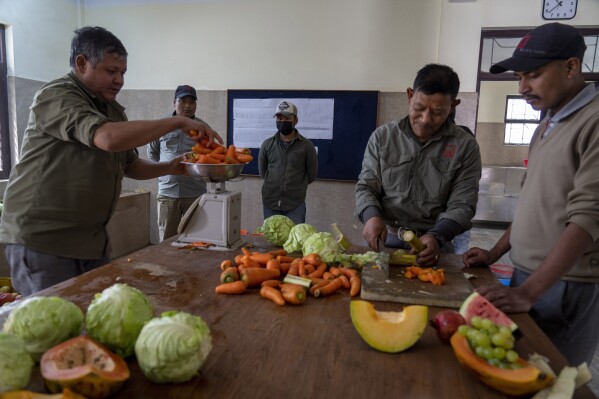 Zoo keepers chop fruits and vegetable to feed animals at the animal kitchen inside Nepal’s Central Zoo in Lalitpur, Nepal, Feb. 21, 2024. The only zoo in Nepal is home to more than 1,100 animals of 114 species, including the Bengal Tiger, Snow Leopard, Red Panda, One-Horned Rhino and the Asian Elephant. (AP Photo/Niranjan Shrestha)
