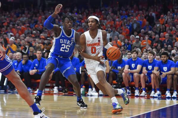 Syracuse forward Chris Bell, right, drives to the basket against Duke forward Mark Mitchell during the first half of an NCAA college basketball game in Syracuse, N.Y., Saturday, Feb. 18, 2023. (AP Photo/Adrian Kraus)