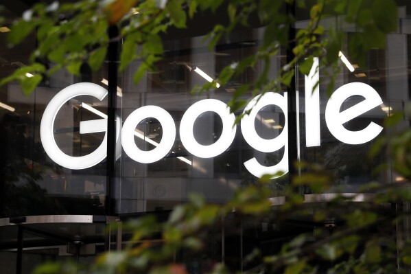 FILE - The Google logo is displayed at their offices, Nov. 1, 2018, in London. Google says, Thursday, July 20, 2023, it is in the early stages of developing artificial intelligence tools to help journalists write stories and headlines, and has discussed its ideas with leaders in the news industry. (AP Photo/Alastair Grant, File)