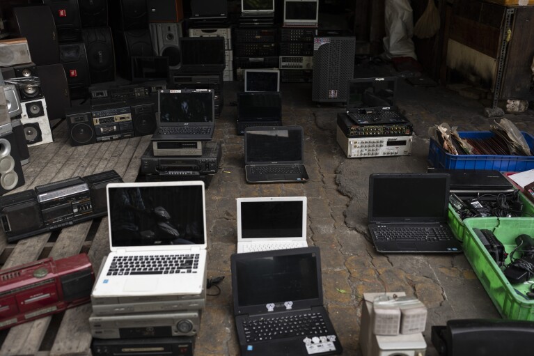 Used laptops and other refurbished electronic devices are for sale in Nhat Tao market, the largest informal recycling market in Ho Chi Minh City, Vietnam, Monday, Jan. 29, 2024. (AP Photo/Jae C. Hong)