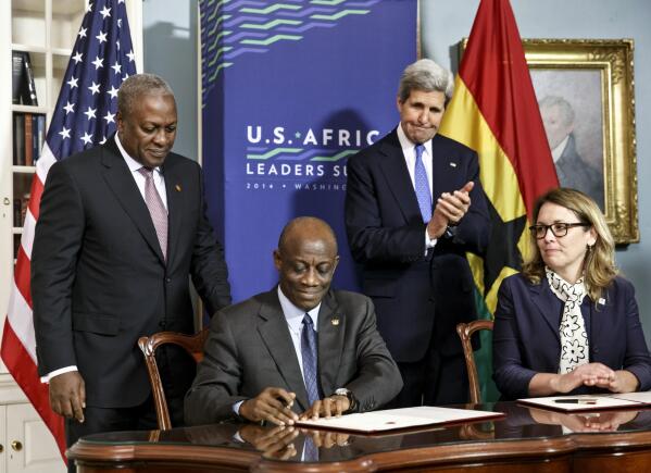 FILE - From left, Ghana's President John Dramani Mahama, Ghana's Finance Minister Seth Terkper, Secretary of State John Kerry, and CEO of the Millennium Challenge Corporation Dana Hyde, participate in the Ghana Compact signing ceremony during the US Africa Leaders Summit at the State Department in Washington on Aug. 5, 2014. A business jet may have experienced problems with its stability before encountering turbulence or some other roughness that caused the death of Hyde, who served in prominent posts in two presidential administrations, officials said Monday, March 6, 2023. (AP Photo/J. Scott Applewhite, File)