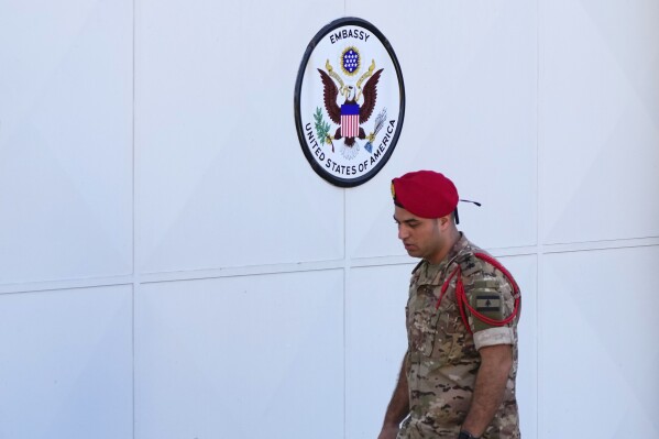 FILE - A Lebanese Army investigator collects forensic evidence outside U.S. Embassy in Aukar, a northern suburb of Beirut, Lebanon, Thursday, Sept. 21, 2023. Lebanese police said Thursday, Sept. 28, that a food delivery driver who opened fire outside the U.S. Embassy in Beirut last week allegedly did so because of a personal grudge against the guards at the compound.(AP Photo/Hassan Ammar, File)