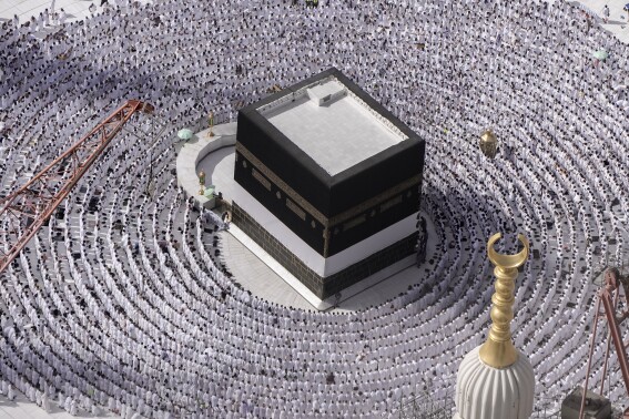 FILE - Muslim pilgrims pray around the Kaaba, the cubic building at the Grand Mosque, during the annual Hajj pilgrimage in Mecca, Saudi Arabia, on June 25, 2023. For the first time in over a decade, 270 Syrians traveled on a direct flight early Tuesday from Damascus to Saudi Arabia for the annual Islamic Hajj pilgrimage, the Syrian Transportation Ministry said. (AP Photo/Amr Nabil, File)