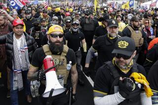 FILE - Proud Boys member Jeremy Joseph Bertino, second from left, joins other supporters of President Donald Trump who are wearing attire associated with the Proud Boys as they attend a rally at Freedom Plaza, Dec. 12, 2020, in Washington. Bertino told jurors on Tuesday, Feb. 21, 2023, that he viewed their far-right extremist organization as "the tip of the spear" after the 2020 election. Bertino is testifying against former Proud Boys national leader Enrique Tarrio and four lieutenants as part of a cooperation deal with federal prosecutors. (AP Photo/Luis M. Alvarez, File)