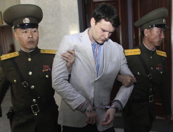 FILE - American student Otto Warmbier, center, is escorted at the Supreme Court in Pyongyang, North Korea on March 16, 2016. (AP Photo/Jon Chol Jin, File)