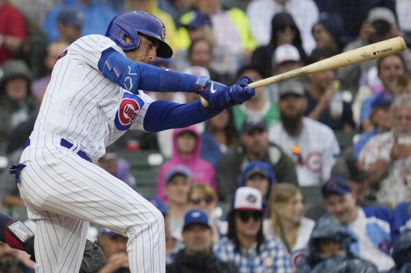 Chicago Cubs' Cody Bellinger hits a one-run double against the Atlanta Braves during the fifth inning of a baseball game in Chicago, Sunday, Aug. 6, 2023. (AP Photo/Nam Y. Huh)