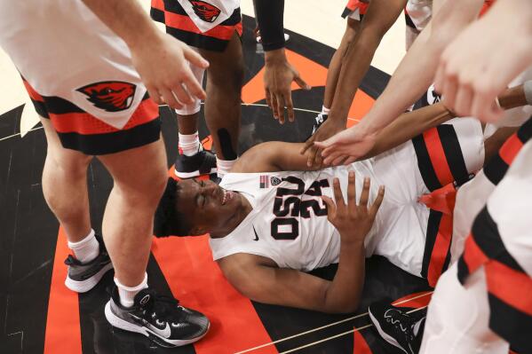Oregon State center KC Ibekwe (24) is helped up from the floor during a celebration of the team's 60-52 win over Colorado in an NCAA college basketball game in Corvallis, Ore., Saturday, Jan. 28, 2023. (AP Photo/Amanda Loman)