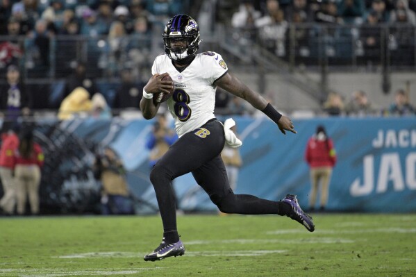 FILE - Baltimore Ravens quarterback Lamar Jackson (8) scrambles for yardage against the Jacksonville Jaguars during the second half of an NFL football game, Sunday, Dec. 17, 2023, in Jacksonville, Fla. Lamar Jackson is a finalist for The Associated Press 2023 NFL Most Valuable Player and Offensive Player of the Year awards. The winners will be announced at NFL Honors on Feb. 8.(AP Photo/Phelan M. Ebenhack, File)