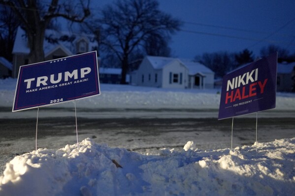 Campaign signs for Republican candidates Donald Trump and Nikki Haley appear outside Franklin Junior High in Des Moines, Iowa, Monday, Jan. 15, 2024. (AP Photo/Carolyn Kaster)