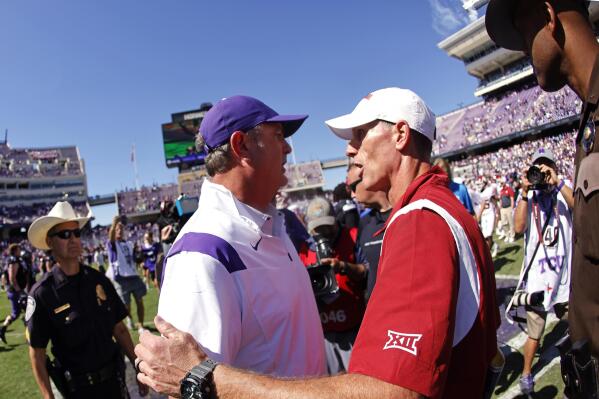 TCU head coach Sonny Dykes, left, meets Oklahoma head coach Brent Venables on the field following TCU's 55-24 win over Oklahoma in an NCAA college football game Saturday, Oct. 1, 2022, in Fort Worth, Texas. (AP Photo/Ron Jenkins)