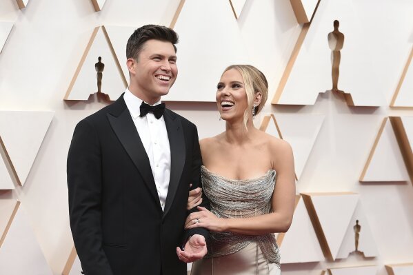 FILE - In this Feb. 9, 2020 file photo, Colin Jost, left, and Scarlett Johansson arrive at the Oscars in Los Angeles.  Meals on Wheels America announced Thursday on Instagram that Johansson and Jost married over the weekend in an intimate ceremony. (Photo by Jordan Strauss/Invision/AP, File)