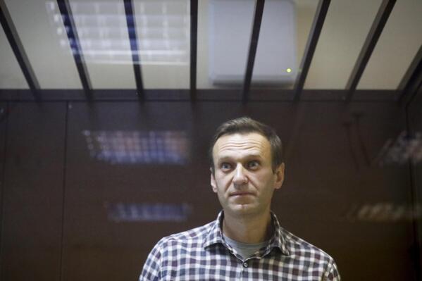 FILE - Russian opposition leader Alexei Navalny stands in a cage in the Babuskinsky District Court in Moscow, Russia, Feb. 20, 2021. Imprisoned Russian opposition leader Alexei Navalny is in failing health because of a new suspected poisoning and is back in a punishment cell after a few days in regular confinement, a spokeswoman said Wednesday, April 12, 2023. (AP Photo/Alexander Zemlianichenko, File)