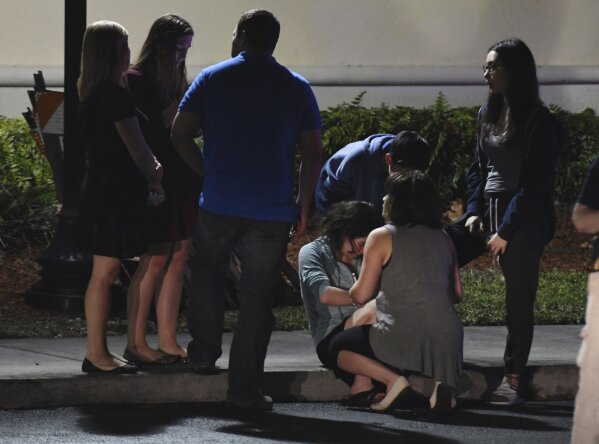 
              Parents meet at a hotel in Coral Springs, Fla., Wednesday, Feb. 14, 2018, to pick up their children, following a shooting at nearby Marjory Stoneman Douglas High in Parkland, Fla. A former student opened fire at the Florida high school Wednesday, killing more than a dozen people and sending scores of students fleeing into the streets. (Jim Rassol/South Florida Sun-Sentinel via AP)
            
