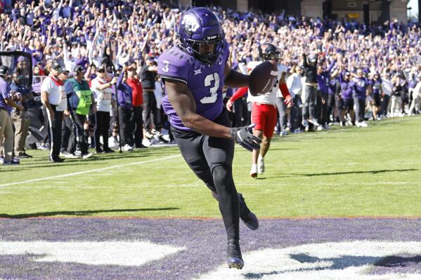 TCU running back Emari Demercado (3) catches a touchdown pass against Texas Tech during the second half of an NCAA college football game Saturday, Nov. 5, 2022, in Fort Worth, Texas. (AP Photo/Ron Jenkins)