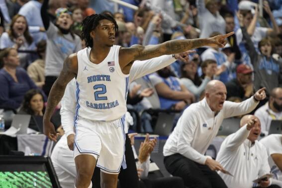 North Carolina guard Caleb Love (2) points to a teammate after making a 3-point basket against Boston College during the second half of an NCAA college basketball game at the Atlantic Coast Conference Tournament in Greensboro, N.C., Wednesday, March 8, 2023. (AP Photo/Chuck Burton)