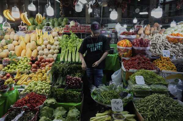 A fruit and vegetable vendor waits for customers in Tajrish traditional bazaar in northern Tehran, Iran, Monday, June 2, 2025. (AP Photo/Vahid Salemi)