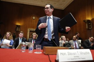 
              Treasury Secretary Steve Mnuchin gets up after testifying about the budget during a Financial Services and General Government subcommittee hearing, Wednesday May 15, 2019, on Capitol Hill in Washington. (AP Photo/Jacquelyn Martin)
            