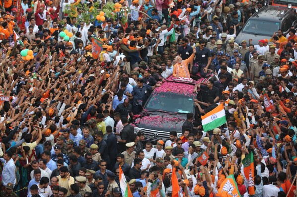 Indian Prime Minister Narendra Modi waves to the crowd during a political campaign road show in Varanasi, India, Thursday, April 25, 2019. (AP Photo/Rajesh Kumar Singh)