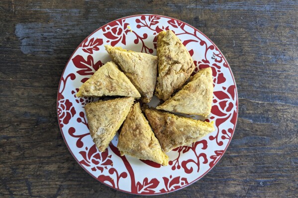 This photo shows a plate of pumpkin scones. Biscuits, pull-apart breads and sweet loaves are all trending as home bakers find the hobby satisfying on many levels. (Kim Cook via AP)
