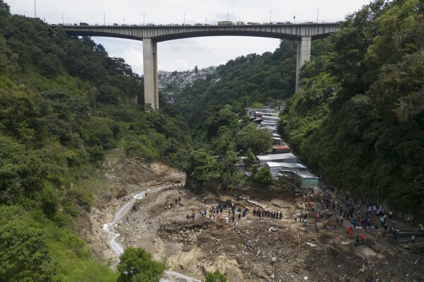 The Naranjo River moves through the "Dios es fiel," or "God is Loyal" shanty on the outskirts of Guatemala City, Monday, Sept. 25, 2023, the day after homes were swept away overnight after heavy rain. (AP Photo/Moises Castillo)