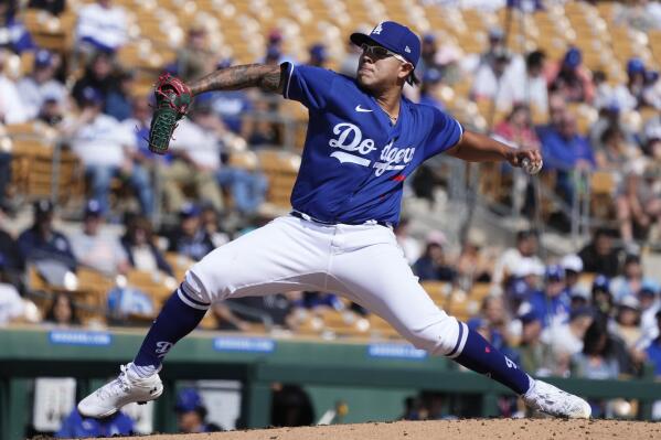 Los Angeles Dodgers starting pitcher Julio Urias throws a pitch against the Cincinnati Reds during the second inning of a spring training baseball game Tuesday, Feb. 28, 2023, in Phoenix. (AP Photo/Ross D. Franklin)