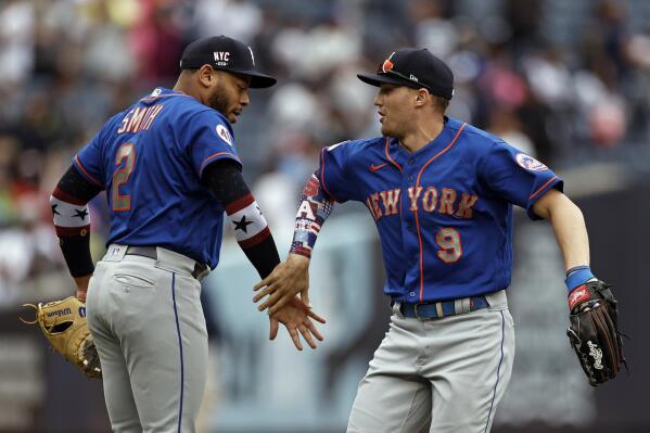 New York Mets center fielder Brandon Nimmo (9) and first baseman Dominic Smith (2) celebrate after defeating the New York Yankees in a baseball game Saturday, July 3, 2021, in New York. (AP Photo/Adam Hunger)