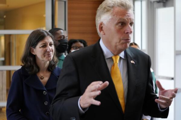 FILE - This July 15, 2021 file photo shows Democratic gubernatorial candidate former Governor, Terry McAuliffe, right, and US Rep. Elaine Luria, D-Va., during a tour of Norfolk State University Thursday July 15, 2021, in Norfolk, Va. McAuliffe issued a call Monday, Aug. 23, 2021 for all Virginia employers to require the COVID-19 vaccine for their workers, as a policy debate over how best to deal with the coronavirus pandemic dominates the closely watched race for governor. His opponent, former business executive and political newcomer Glenn Youngkin, who is vaccinated, has consistently urged voters to get the shot but has said he opposes vaccine mandates. (AP Photo/Steve Helber)