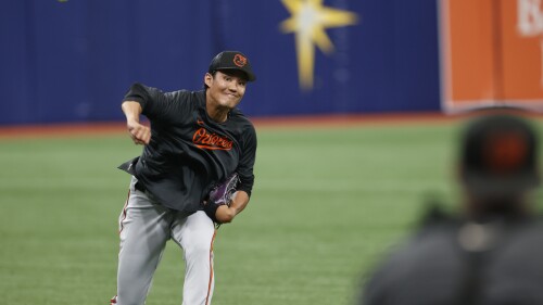Baltimore Orioles relief pitcher Shintaro Fujinami warms up in the outfield during batting practice before playing against the Tampa Bay Rays in a baseball game Friday, July 21, 2023, in St. Petersburg, Fla. (AP Photo/Scott Audette)
