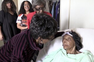 
              FILE - In this Sept. 22, 2018 file photo, Lessie Brown, right, is visited by her daughters, Verline Wilson, foreground, and Vivian Hatcher, third from left, and other family and friends at her home in Cleveland Heights, Ohio. A grandson said Brown, the 114-year-old Ohio woman who was believed to be the oldest person in the United States, died Tuesday. Jan. 8, 2019. (David Petkiewicz/The Plain Dealer via AP)
            