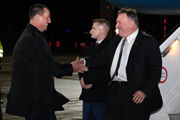 Secretary of State Mike Pompeo is greeted by U.S. ambassador to Germany Richard Grenell as he arrives at Munich International Airport, in Munich, Germany on Thursday, February 13, 2020. (Andrew Caballero-Reynolds/Pool via AP)