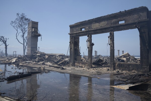 FILE - Wildfire wreckage is visible on Aug. 9, 2023, in Lahaina, Hawaii. Experts say the fires are likely to transform the landscape in unwanted ways, hasten erosion, send sediment into waterways and degrade coral that’s critically important to the islands, marine life and people who live near it. (Tiffany Kidder Winn via AP, File)