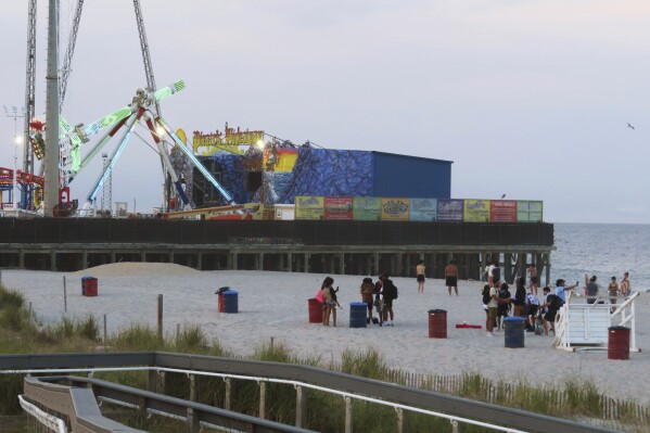 Young people gather peacefully on the beach in Seaside Heights, N.J. on June 2, 2023. Officials and residents of several New Jersey shore towns say the state's law decriminalizing marijuana use is having an unintended effect: emboldening large groups of teenagers to run amok on beaches and boardwalks, knowing there is little chance of them getting in trouble for it. (AP Photo/Wayne Parry)