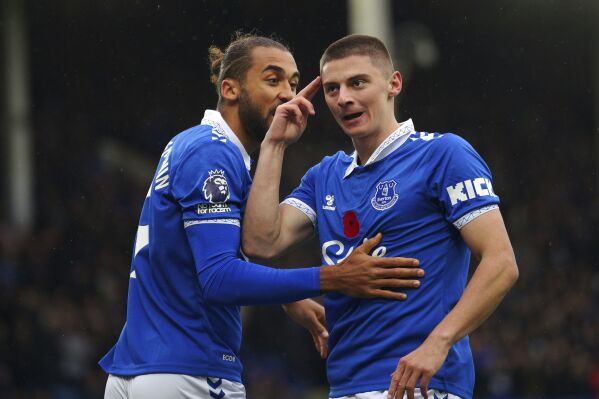 Everton's Vitaliy Mykolenko, right, celebrates scoring during the English Premier League soccer match between Everton and Brighton & Hove Albion at Goodison Park, Liverpool, England, Saturday Nov. 4, 2023. (Peter Byrne/PA via AP)