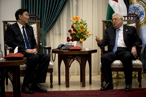 FILE - Palestinian President Mahmoud Abbas, right, speaks with Chinese Middle East envoy Zhai Jun, during a meeting at the President's office in the West Bank city of Ramallah, Dec. 7, 2019. Its Middle East envoy, Zhai Jun, talked to Palestinian and Egyptian officials by phone this past week, calling for an immediate cease-fire and humanitarian support for the Palestinian people. Zhai also phoned Israeli officials to say China “has no selfish interests on the Palestinian issue but has always stood on the side of peace, on the side of fairness and justice.” He said “China is willing to work with the international community to promote peace and encourage talks.” (AP Photo/Majdi Mohammed, File)