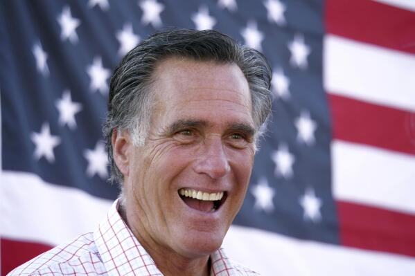 FILE - In this June 20, 2018, file photo, Mitt Romney smiles during a campaign event in American Fork, Utah. Mitt Romney isn't up for reelection this year, but his name is surfacing in Republican primaries throughout the nation. Candidates are using the label "Mitt Romney Republican" to frame opponents as insufficiently conservative and enemies of the Trump-era GOP Candidates have employed the concept in attack ads and talking points in Michigan, Ohio and Pennsylvania. (AP Photo/Rick Bowmer, File)