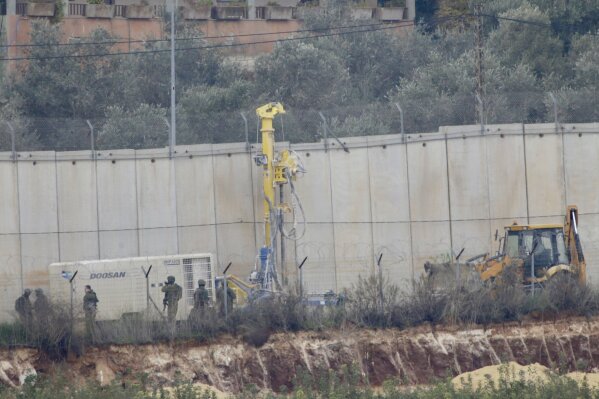 
              Israeli military digger works on the border with Lebanon in the northern Israeli town of Metula, Tuesday, Dec. 4, 2018. The Israeli military launched an operation on Tuesday to "expose and thwart" tunnels built by the Hezbollah militant group it says stretch from Lebanon into northern Israel. (AP Photo/Ariel Schalit)
            