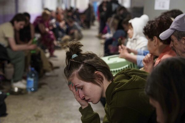 A woman sits in a school basement being used as a shelter after a Russian airstrike on a residential neighborhood in Kyiv, Ukraine, on Thursday, April 24, 2025. (AP Photo/Evgeniy Maloletka)
