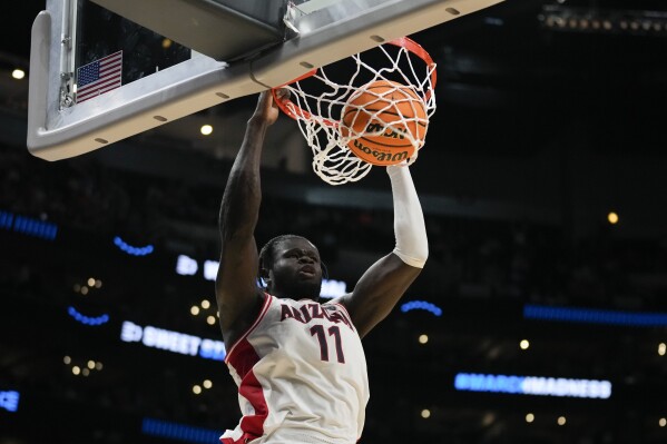 Arizona center Oumar Ballo (11) dunks during the second half of a Sweet 16 college basketball game against Clemson in the NCAA tournament Thursday, March 28, 2024, in Los Angeles. (AP Photo/Ashley Landis)