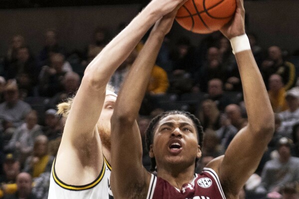 FILE - South Carolina's Collin Murray-Boyles, right, has his shot blocked by Missouri's Connor Vanover, left, during the first half of an NCAA college basketball game Jan. 13, 2024, in Columbia, Mo. South Carolina is No. 15 in the latest AP Top 25 poll for its first ranking in nearly seven years. (AP Photo/L.G. Patterson, File)